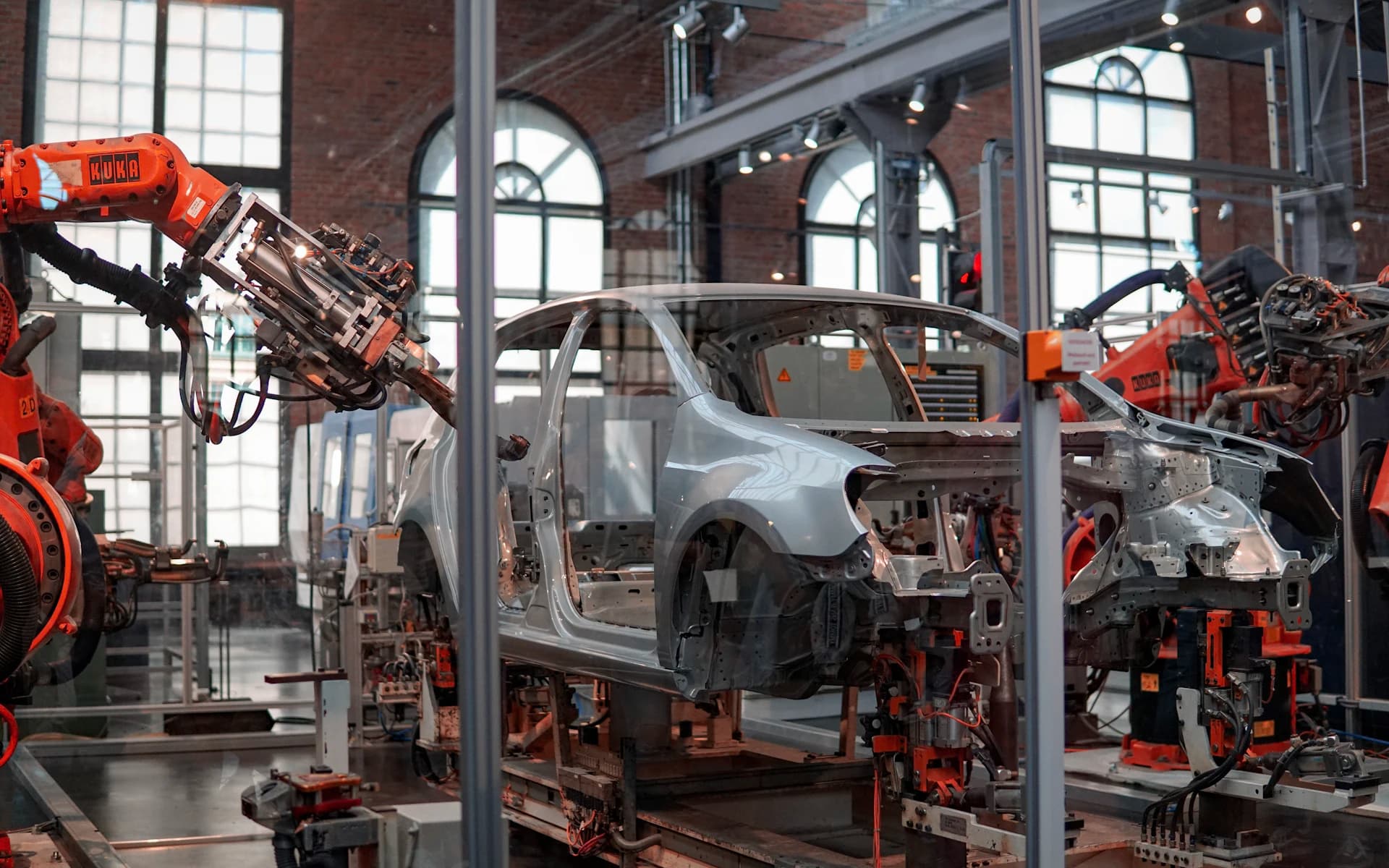 Industrial robotic arms working on a vehicle assembly line.